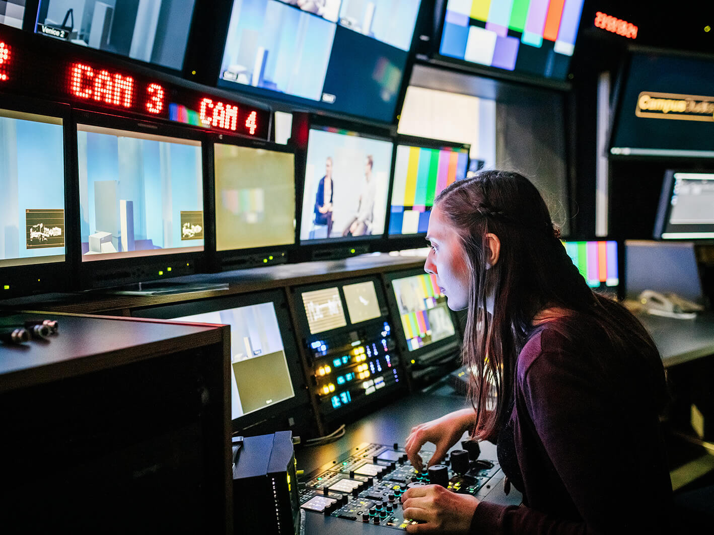 Woman in video control room monitoring screens