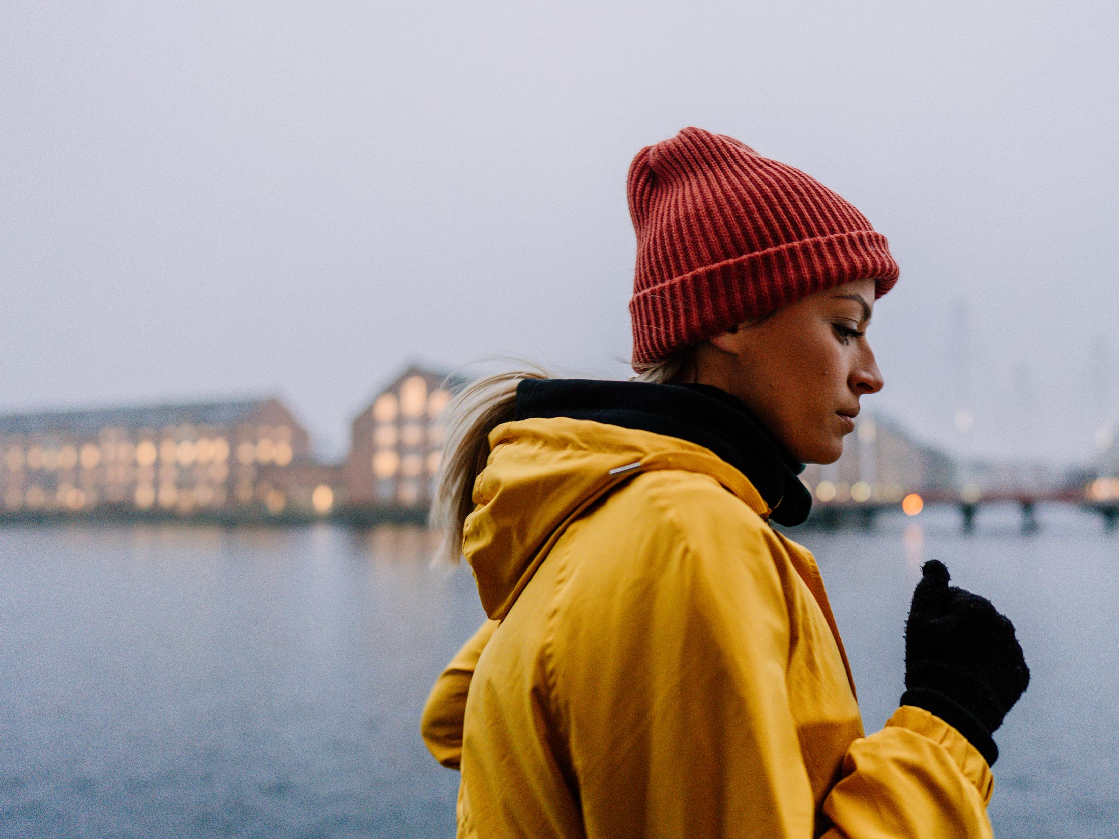 Photo of a young woman running along the canal in Denmark