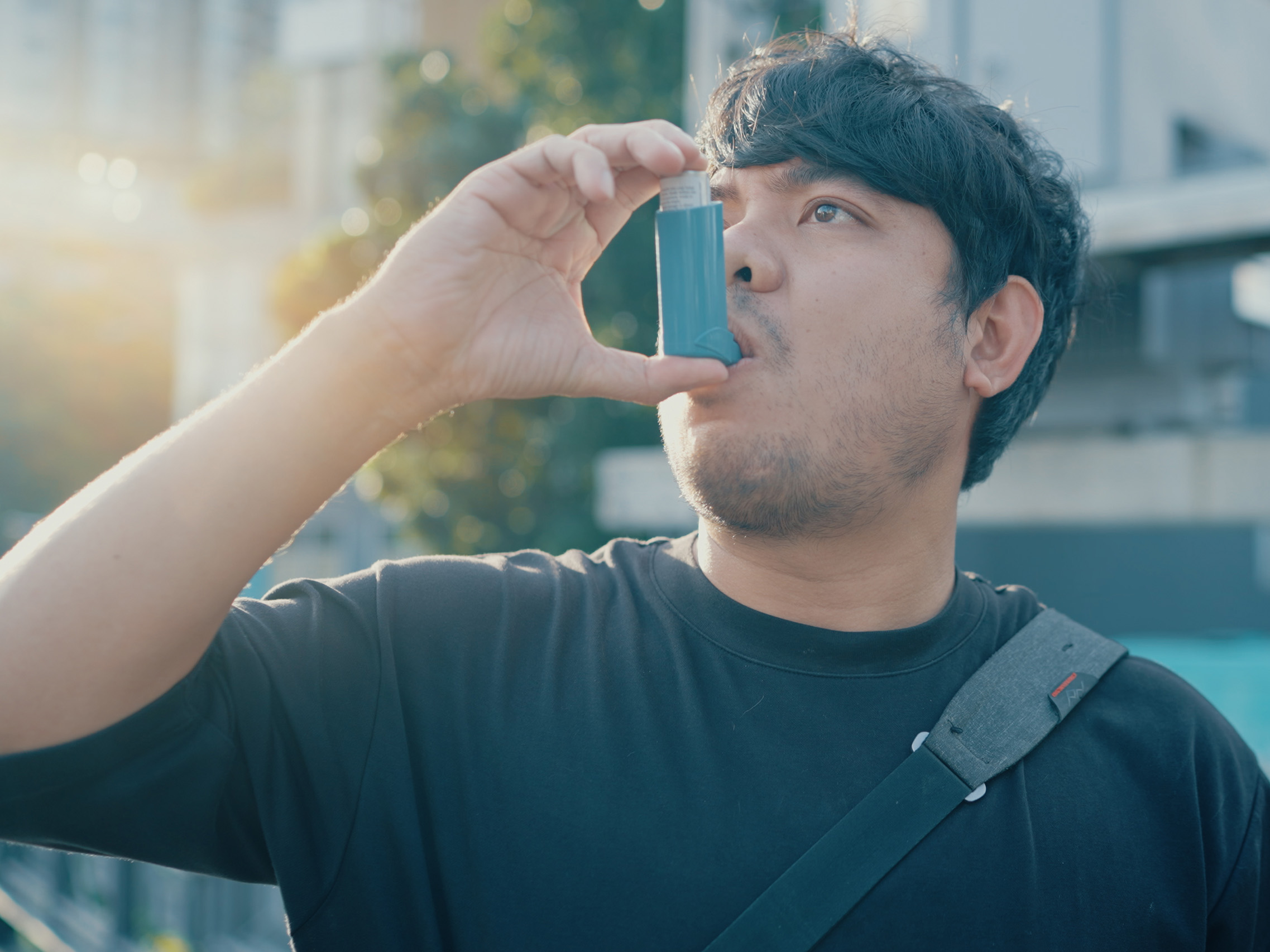Man using inhaler while outside