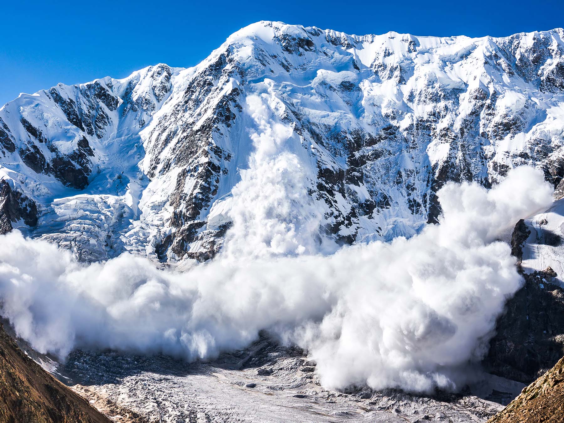 Snow avalanche coming down a big mountain