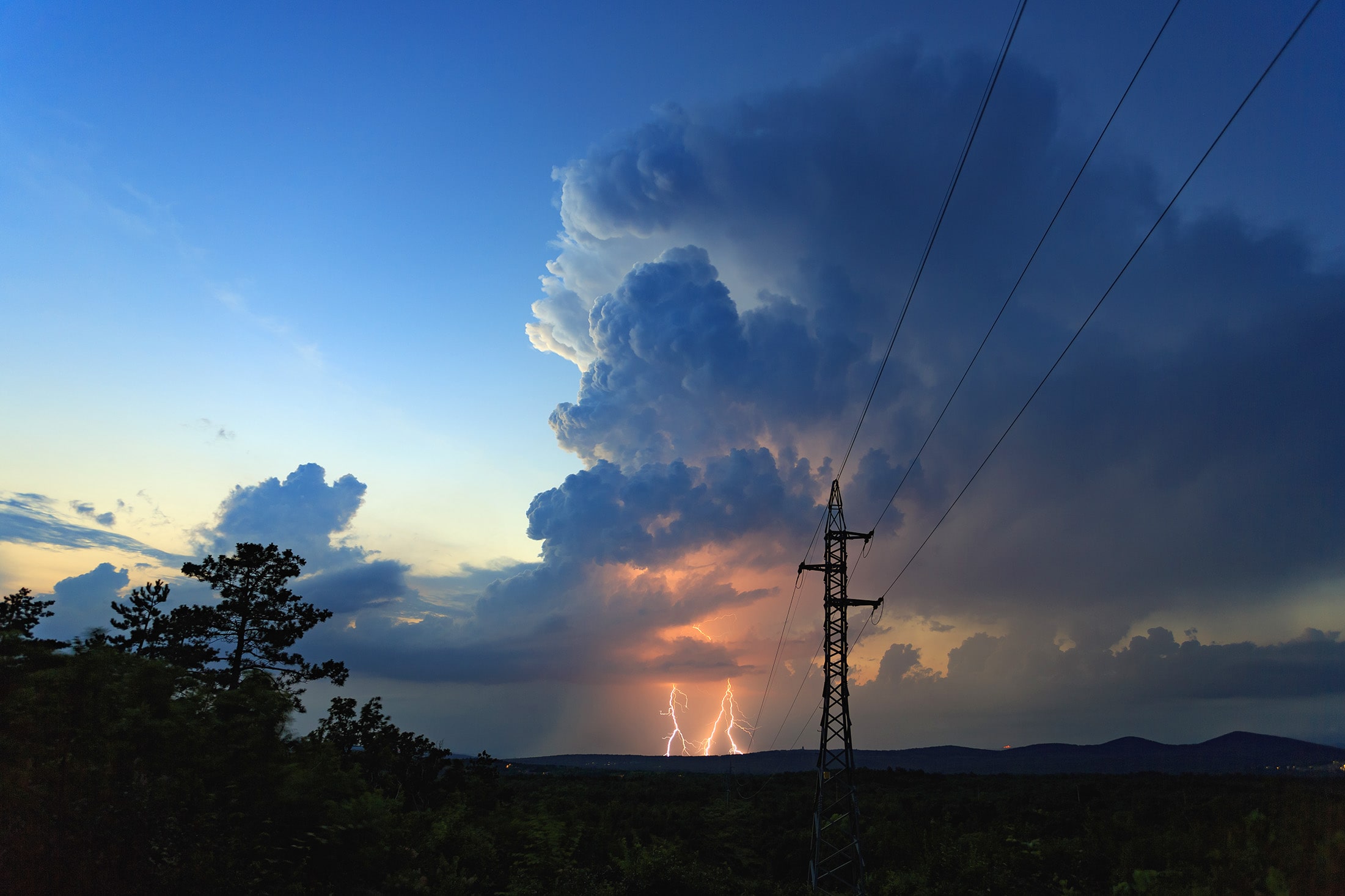Power line with lightning in the sky