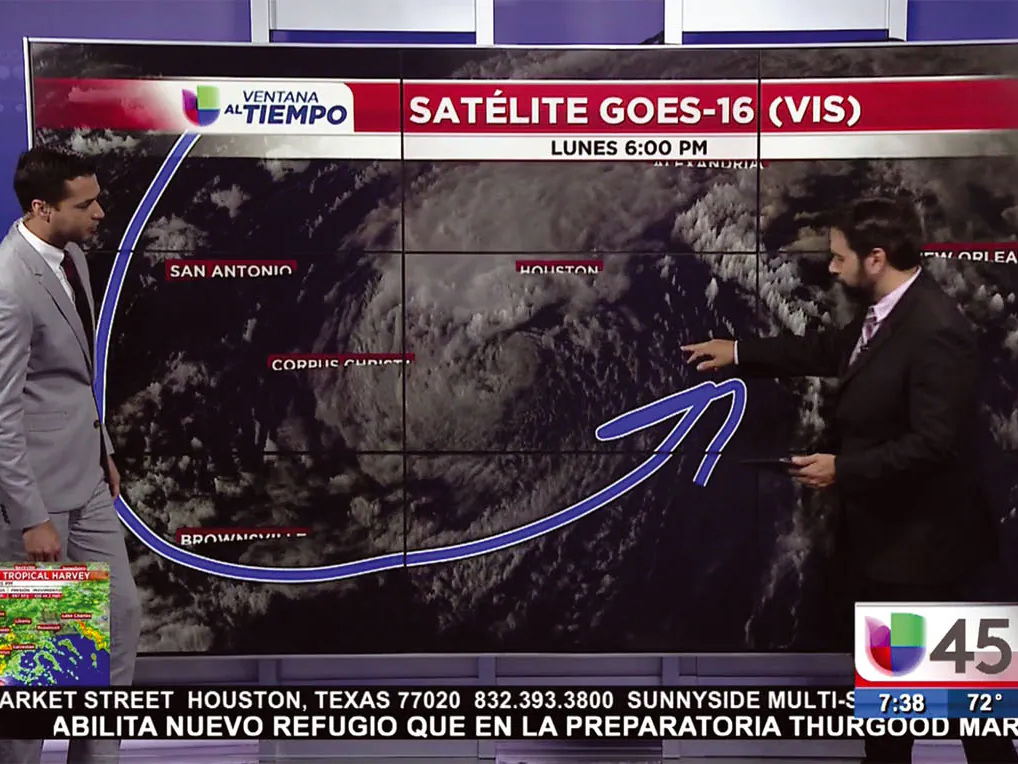 Two hispanic men meteorologists presenting forecast in Spanish and showing storm clouds over Texas
