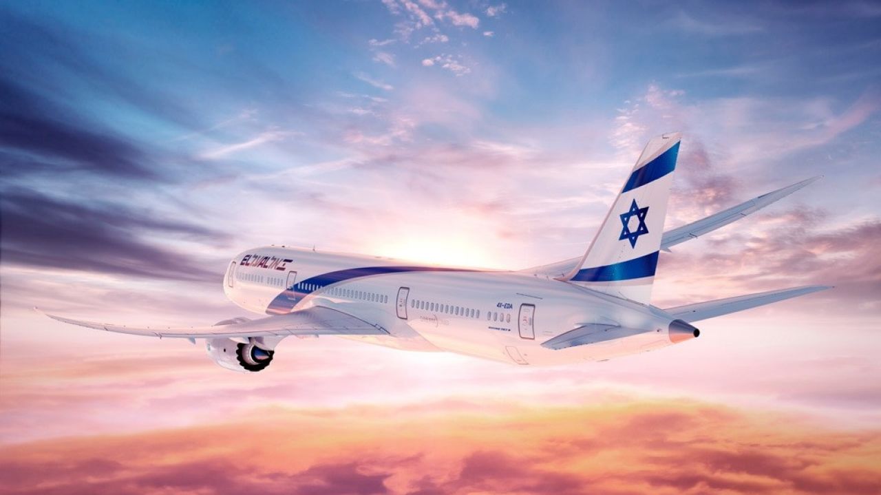 An El Al jet plane flying in the sky above the clouds