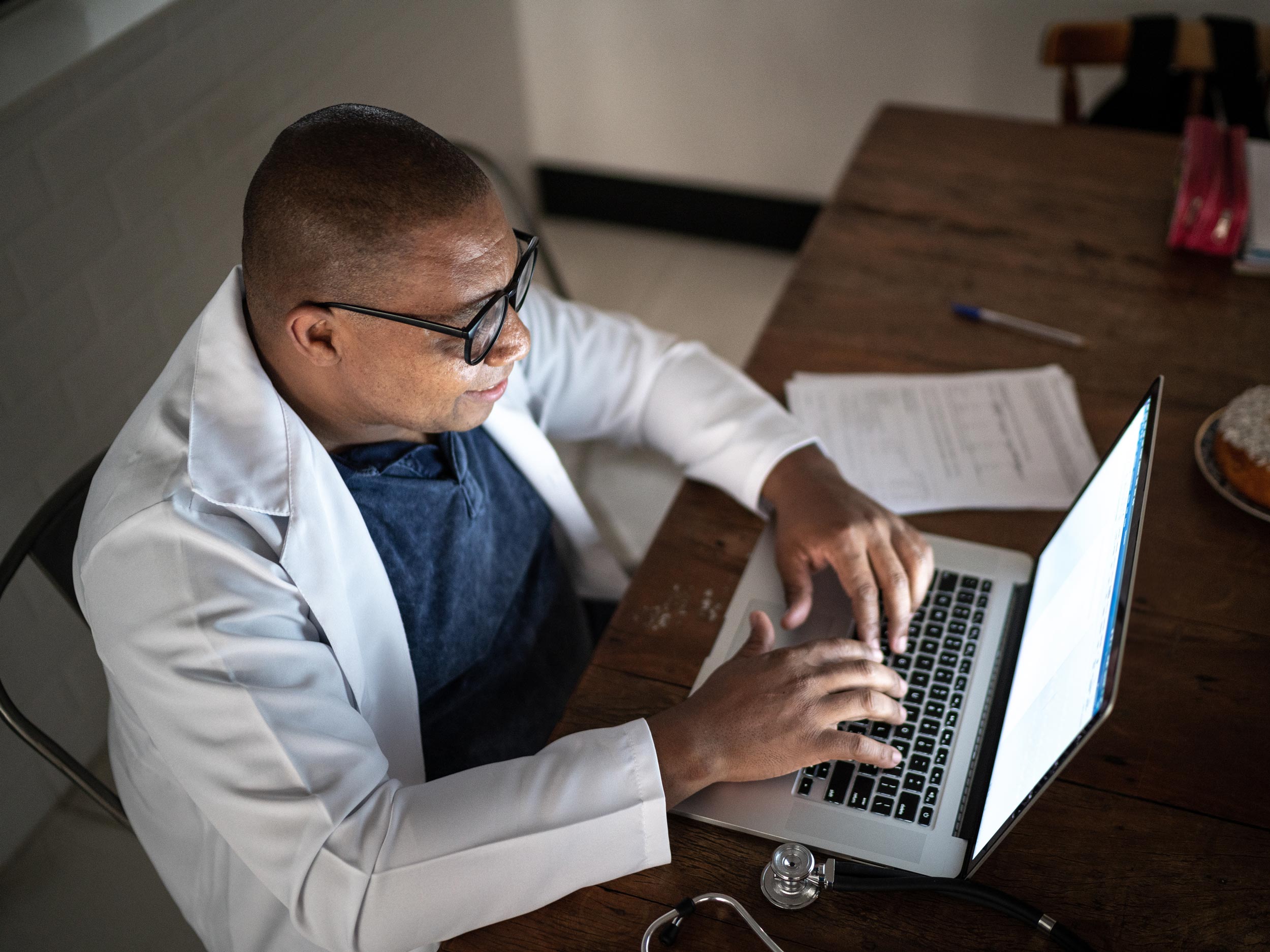 Doctor using laptop working at home