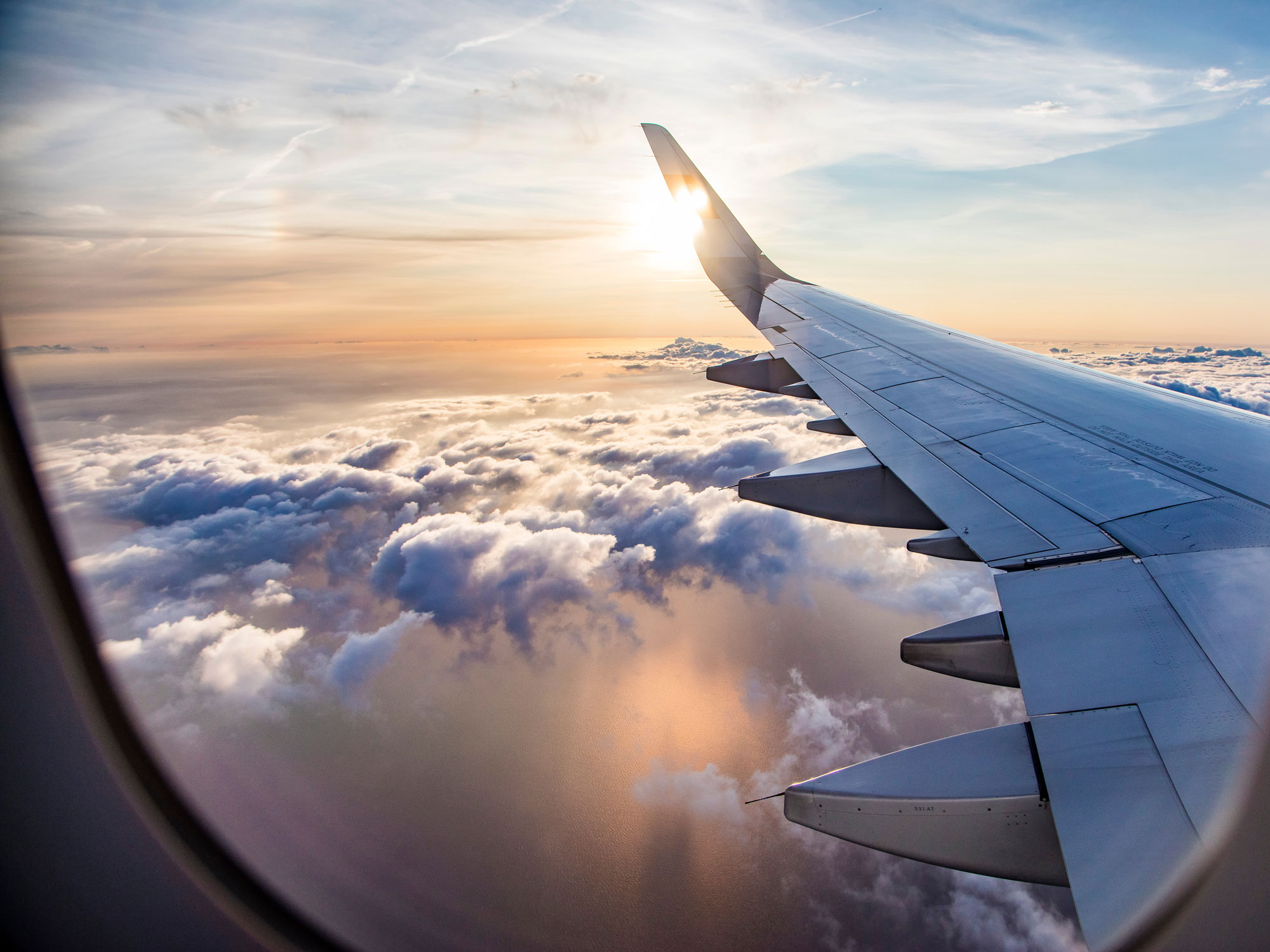 hero-aviation-airplane-wing-sky-clouds-shutterstock_1020928975