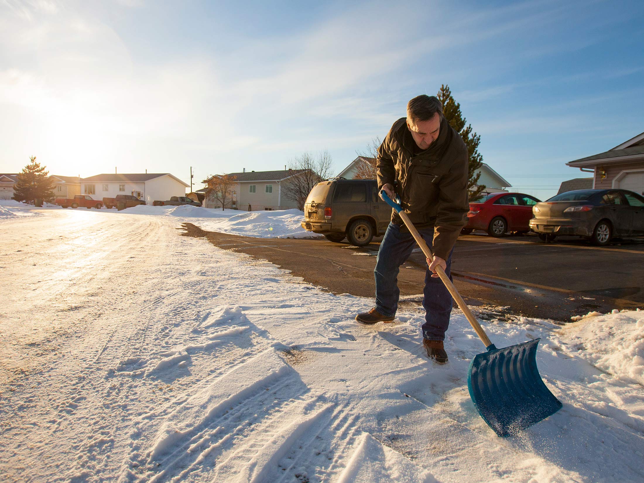 Man snow shoveling his driveway