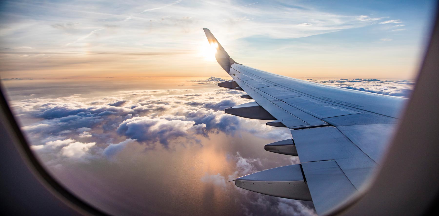 hero-wide-aviation-airplane-wing-sky-clouds-shutterstock_1020928975