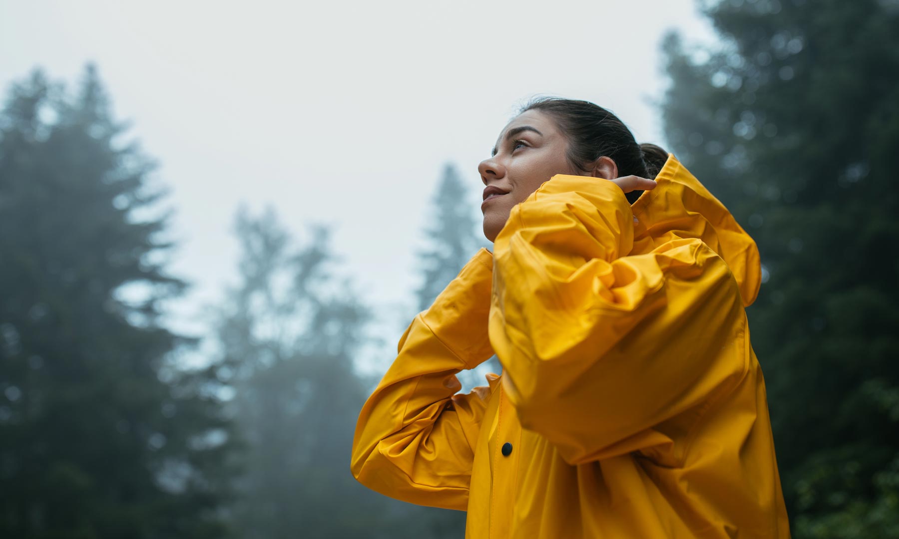 hero-woman-raincoat-forest-GettyImages-1318489427
