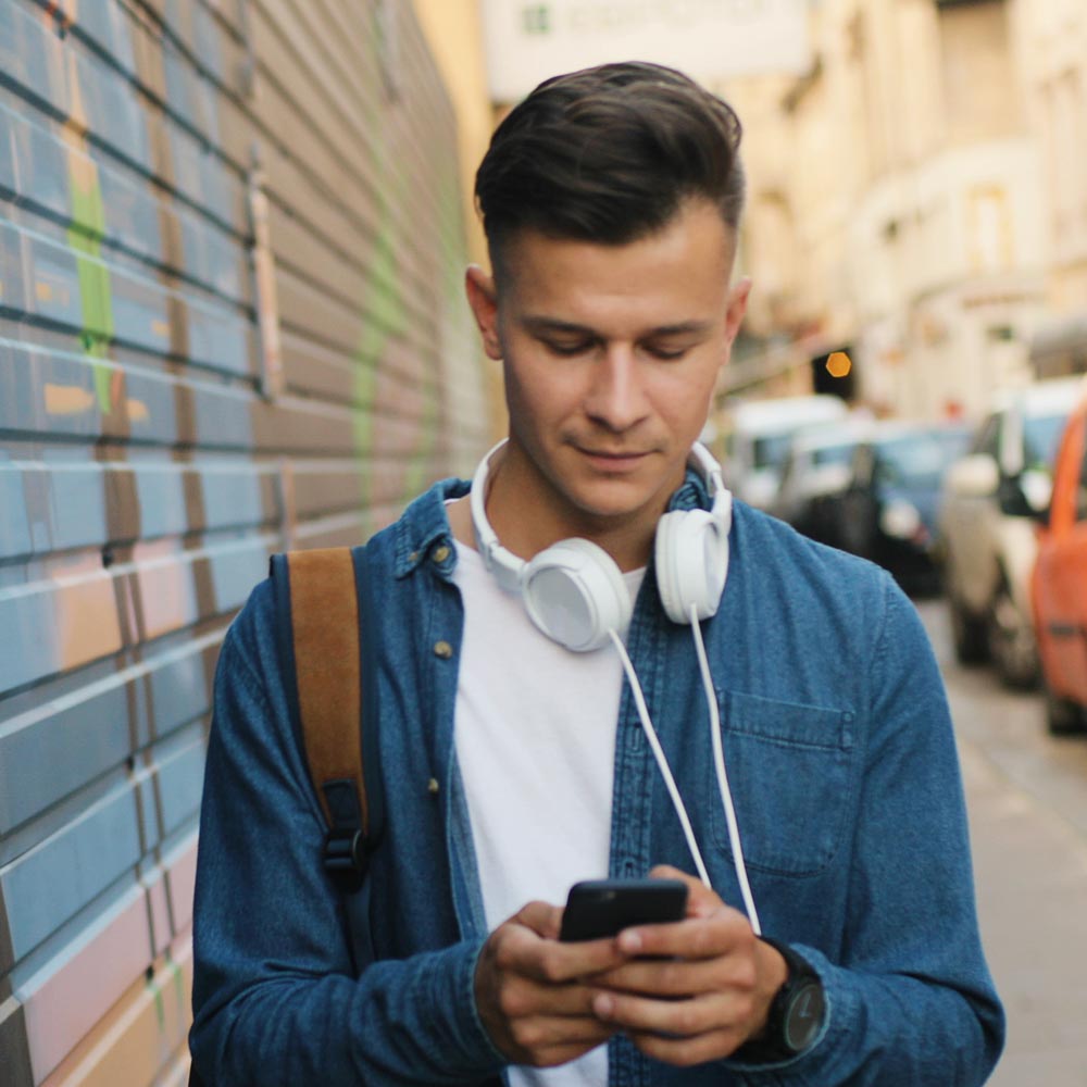 thumb-man-phone-city-street-shutterstock_728454673