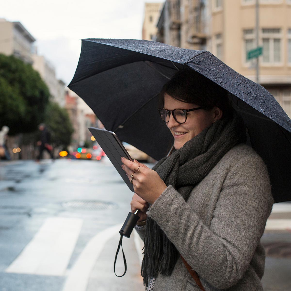 thumb-woman-rain-umbrella-ipad-shutterstock_offset_2290265709