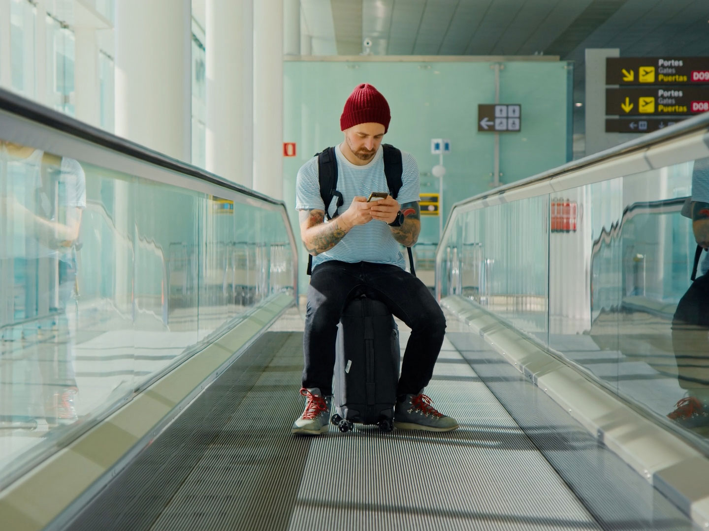 white-man-airport-travel-phone-shutterstock_1052804039