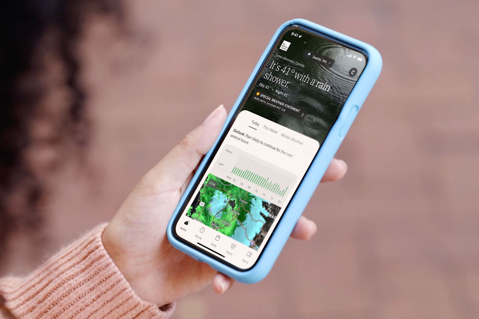 The Weather Channel app in hand