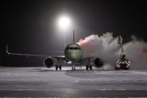 Ground deicing of a passenger airliner on the night airport apron at winter