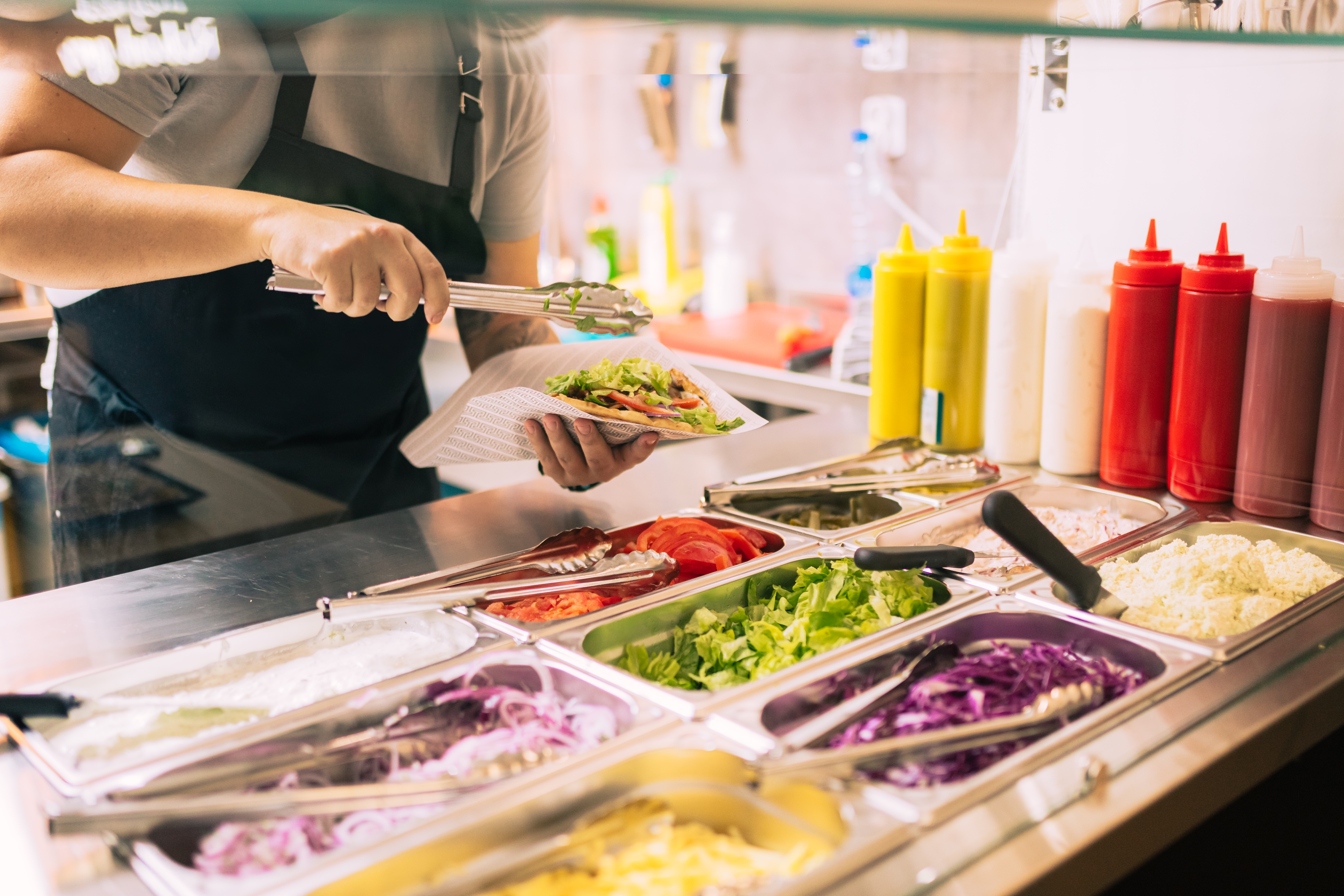 Service worker at preparing food at a quick serve restaurant