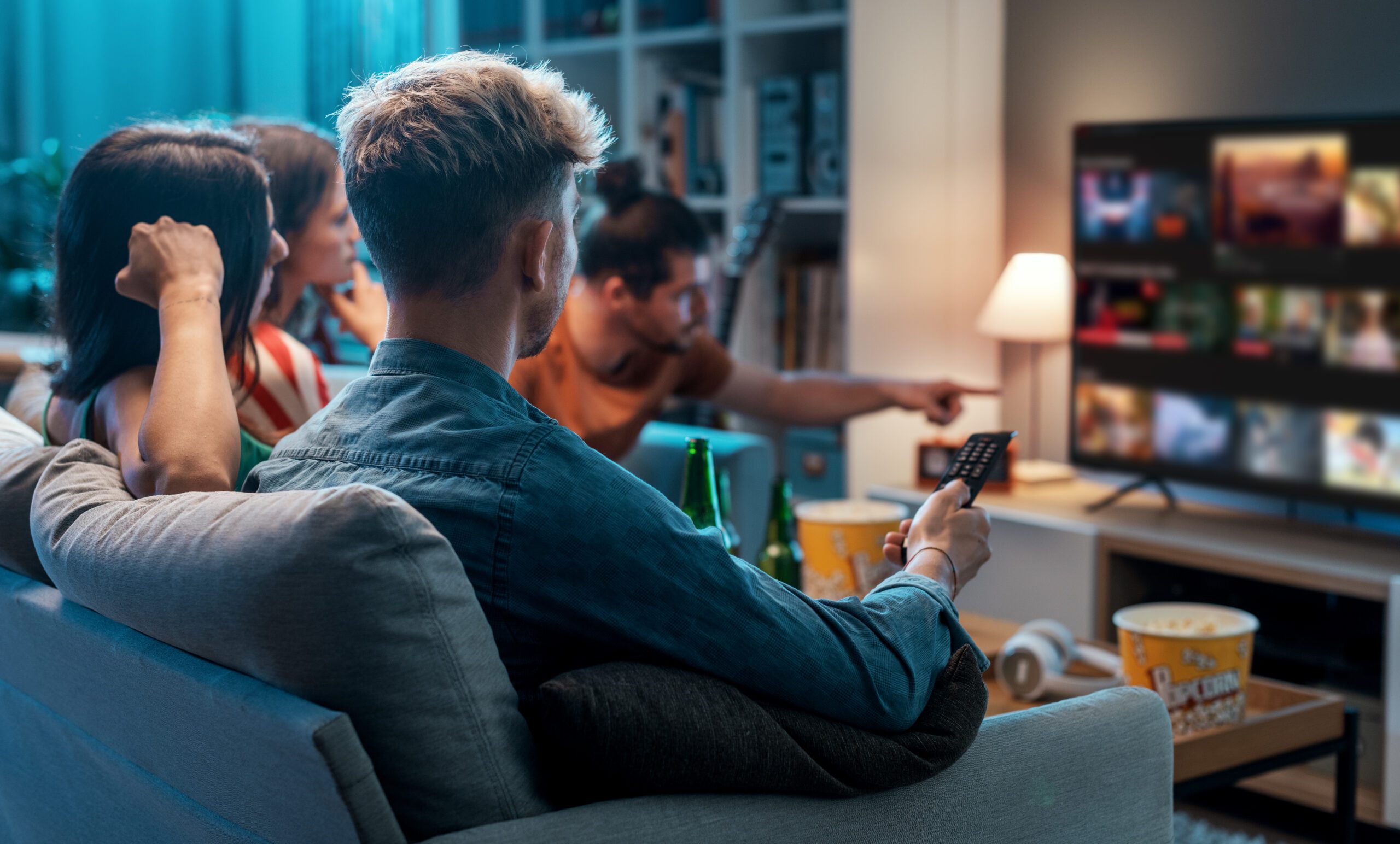 Friends choosing a movie to watch together at home, video on demand
