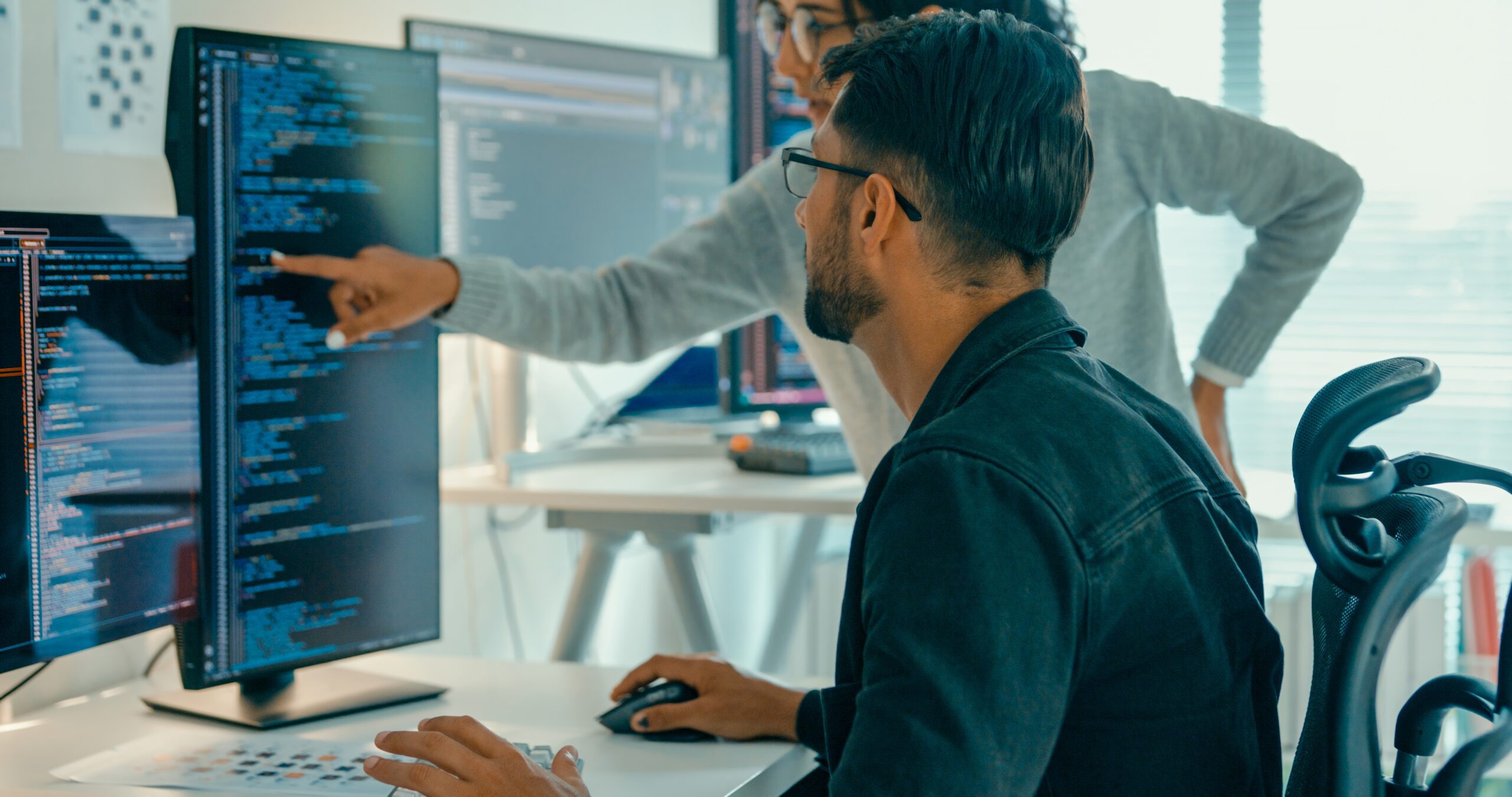 Tech team professionals collaborate discuss scalable API architecture in modern office.