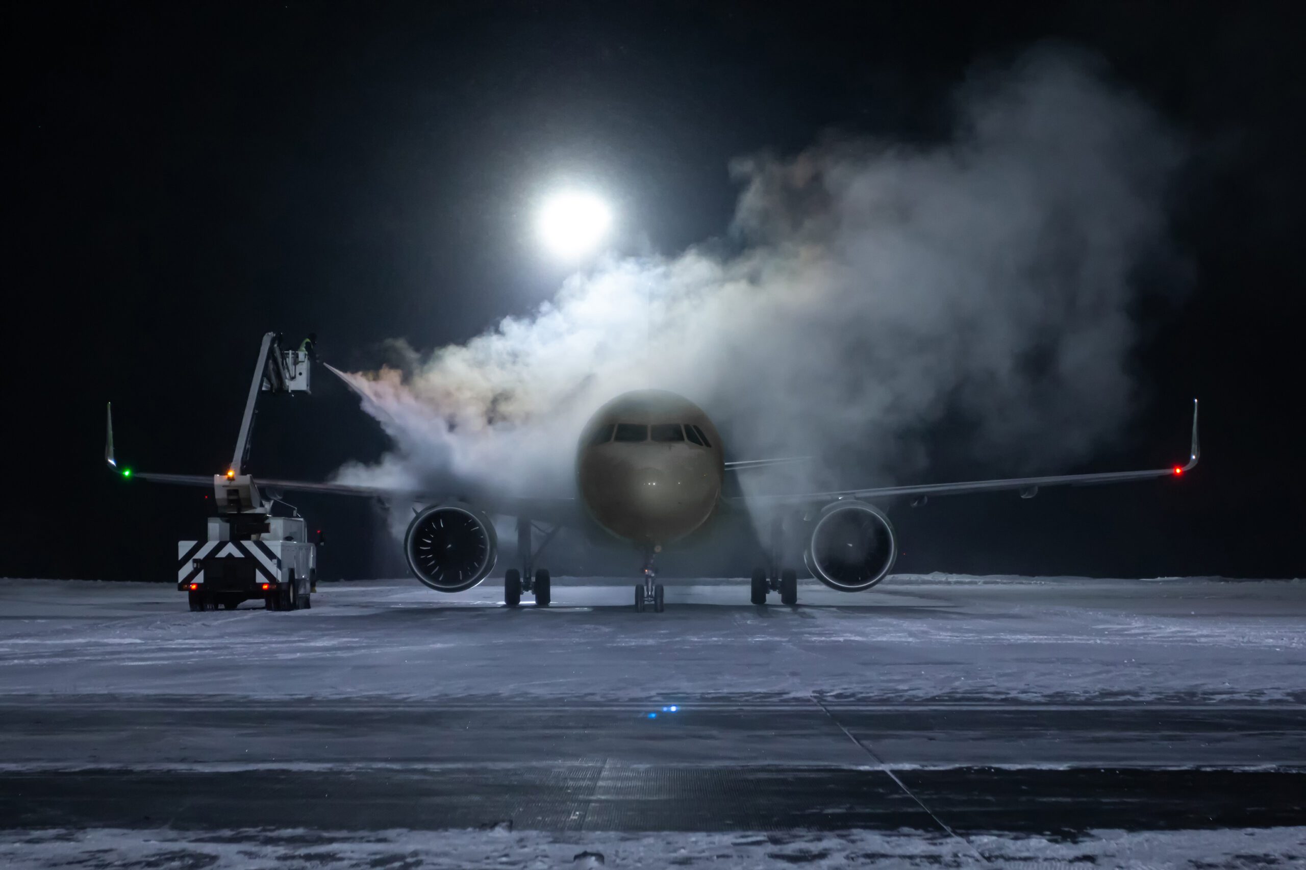 Ground deicing of a passenger aircraft on the night airport apron at winter