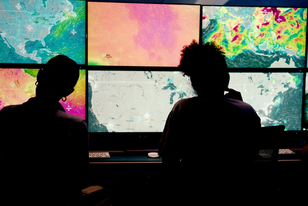 Meteorologists reviewing weather radar.
