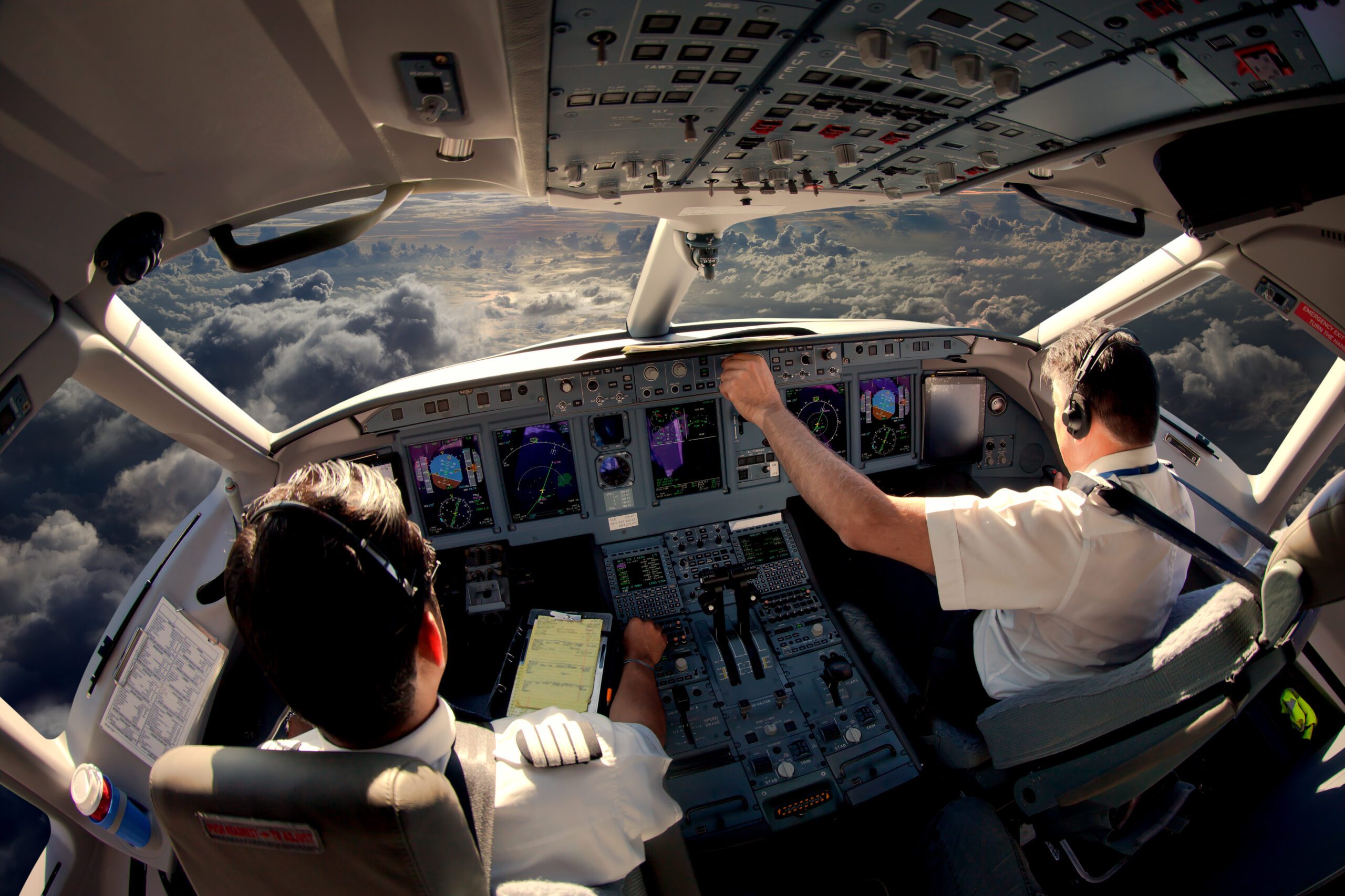 Flight Deck of modern passenger jet aircraft. Pilots at work.