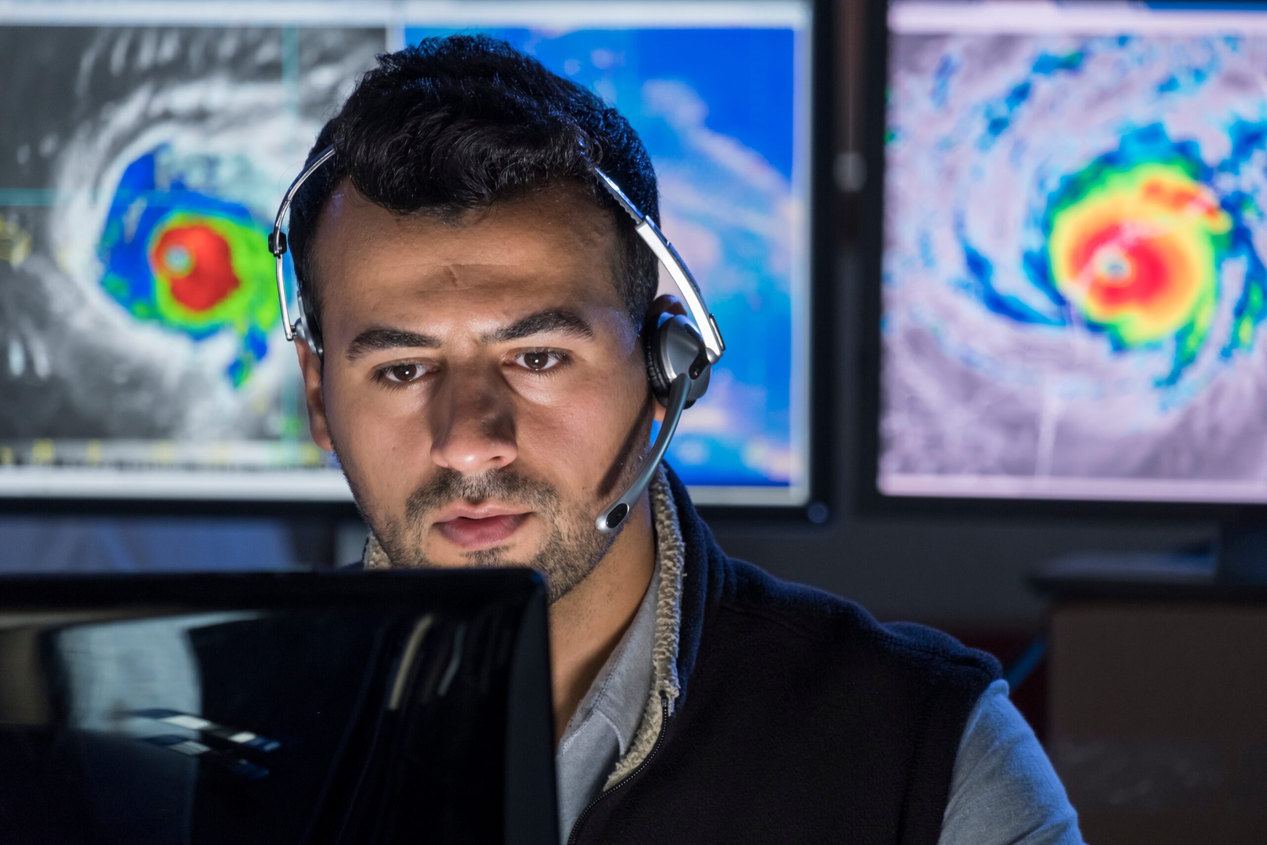 Meteorologist monitoring storms on his computer screen, close up shot