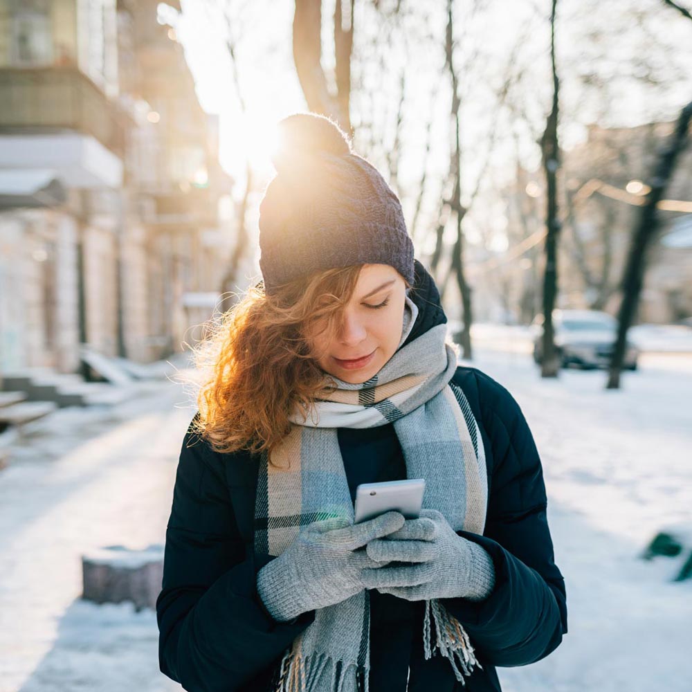 Woman outside in winter using her mobile phone